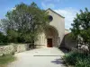 Ganagobie monastery - Romanesque church of the Benedictine convent and path lined with trees and iris (flowers)