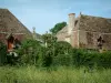 Gardens of the Notre-Dame d'Orsan priory - Buildings of the ancient monastery with plants and trees