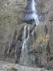 Gavarnie cirque - Great waterfall, cliff of the natural cirque and hikers at the foot of the waterfall; in the Pyrenees National Park