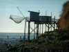 Gironde estuary - Ebb tide, fishermen's huts built on stilts, suspended carrelet (fishing net), in Meschers-sur-Gironde, and the Gironde estuary