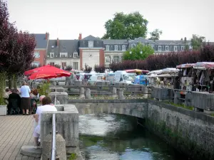 Gisors - Flowery bridge spanning the canal, café terrace, market and facades of the town