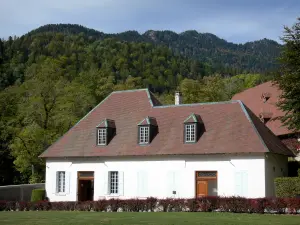 Grande Chartreuse monastery - Correrie of the Grande Chartreuse: building housing the shop of the Grande Chartreuse museum, forest in background