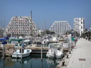 La Grande-Motte - Seaside resort: pyramid-shaped buildings, boats and sailboats of the sailing port and the quay