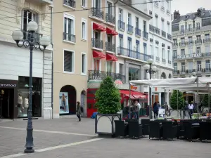 Grenoble - Facades, shops, lampposts and café terraces of the Place Grenette square