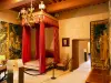 Grignan castle - Interior of the chateau: Tournon bedroom with red four-poster bed and tapestries