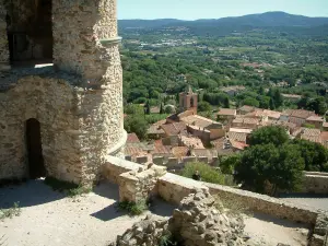 Grimaud - Ruins of the castle, view of houses and church bell tower in the medieval village, forests and surrounding hills