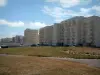 Hardelot-Plage - Grassland, buildings of the seaside resort and clouds in the sky; in the Regional Nature Park of Opal Capes and Marshes