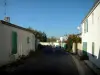 Île de Ré - La Flotte : rue bordée de maisons blanches aux volets verts