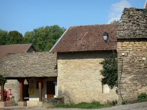 L'Isle Crémieu plateau - Facades of stone houses and roofs with slate and terra cotta tiles of a village