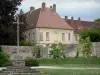 Jouarre abbey - Monolith cross on the Place Saint-Paul square and buildings of the Notre-Dame de Jouarre abbey (Benedictine abbey)