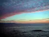 Landscapes of the French Riviera coast - Blue sky with pink clouds at the sunrise, the Mediterranean Sea and the coasts far off