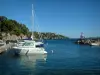 Landscapes of the French Riviera coast - Giens peninsula: the Mediterranean Sea, moored boats and small lighthouse of the Niel port, wild coasts and pine forest of the peninsula
