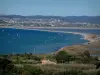 Landscapes of the French Riviera coast - From the Giens peninsula, view of the Mediterranean Sea, kitesurfs and windsurfing boards