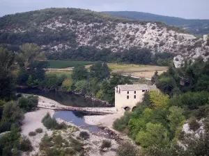 Landscapes of the Gard - Cèze valley: River Cèze, mill, trees at the edge of the water and hills