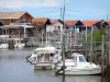 Landscapes of the Gironde - Arcachon bay: port of Larros with its oyster huts and its boats moored; in the town of Gujan-Mestras 