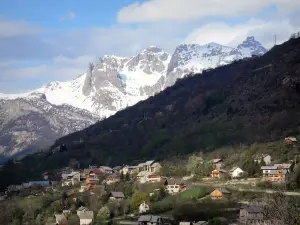 Landscapes of the Hautes-Alpes - Chalets, trees and mountain dotted with snow, in Briançon