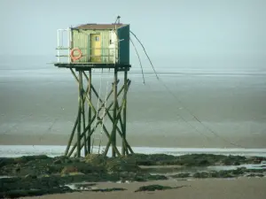 Landscapes of the Loire-Atlantique coast - Fisherman's hut built on stilts and cliffs at ebb tide