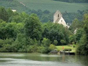 Landscapes of Picardy - Marne valley: Gothic church of Mézy-Mills, Marne river, bank planted with trees, vines of the Champagne vineyards in the background