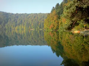 Landscapes of the Puy-de-Dôme - Auvergne Volcanic Regional Nature Park: Pavin lake surrounded by trees with autumn colours, in the Sancy mountains (Monts Dore)