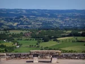 Landscapes of the Quercy - Stone bench with view of fields, prairies, houses, trees and small hills