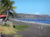 Landscapes of Réunion - Children running on the black sand beach of Saint-Paul