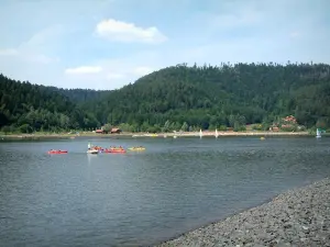 Landscapes of the Vosges - Shore, lake with kayaks and boats, trees (forest) in background and clouds in the sky