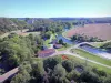 Landscapes of the Yonne - Aerial view of the Yonne river and the Nivernais canal lined with trees, in the town of Mailly-le-Château