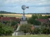 Landschappen van de Aube - Wind, bomen en huizen van een dorp, veld met hooibalen op de achtergrond