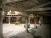 Lautrec - Under the arches of the Halles square (main square) with view of wooden pillars and flowers