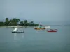 Lérins island - Sainte-Marguerite island: sea with boats, beach, pines trees and coast of the French Riviera in background