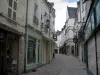 Loches - Street of the old town and its houses with facades decorated with lampposts and with forged iron shop signs