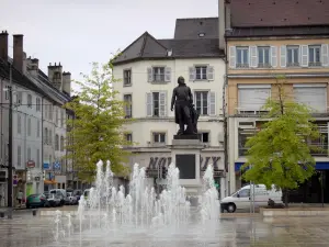 Lons-le-Saunier - Liberté square: statue of General Lecourbe, fountain with jets, shops and building facades