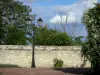 Loudun - Lamppost, stone wall, trees and cloudy sky