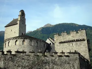 Luz-Saint-Sauveur church - Saint-André fortified church (church of the Templars) with its two towers and crenellated walls, mountains in the background