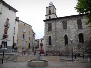 Manosque - Saint-Sauveur church and its bell tower topped by a campanile, fountain and houses of the old town