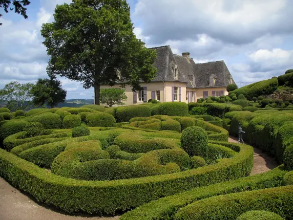 Marqueyssac gardens - Castle, hand-clipped box trees and clouds in the sky, in the Dordogne valley, in Périgord