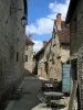 Martel - Narrow street, café terrace and stone houses of the city, in the Quercy