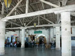 Mauvezin - Stone pillars and wooden structure of the covered market hall, café terrace 