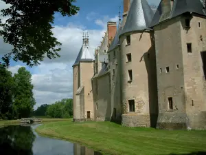 Meillant castle - Towers of the castle and the moats, clouds in the sky