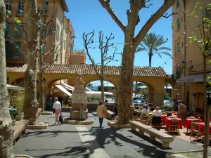 Menton - Small square colourful with plane trees, arches and café terrace