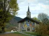 Méribel - Church decorated with frescoes, trees, house and forest of the ski resort (winter sports)