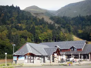 Le Mont-Dore - Ski resort: building, café terrace and trees; in the Massif du Sancy mountains (Monts Dore), in the Auvergne Volcanic Regional Nature Park