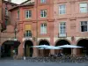 Montauban - Arcaded houses and café terrace on the Place Nationale square