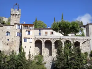 Montbrun-les-Bains - Belfry surmounted by a wrought iron campanile and houses of the medieval village