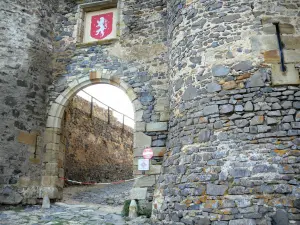 Montmorin castle - Fortified gate topped with the coat of arms of the castle