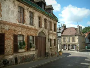 Montreuil-sur-Mer - Ancient brick-built residence, houses in the city and clouds in the sky