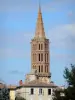 Montricoux - Toulouse-style bell tower of the Saint-Pierre church overlooking the houses of the village 