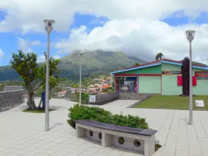 Le Morne-Rouge - Small square with a snack overlooking the houses of the town at the foot of Mount Pelee volcano