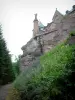Mount Sainte-Odile - Convent (monastery) perched on the pink sandstone cliff, footpath, bushes and trees