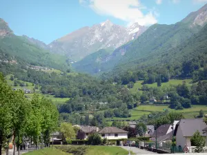 Ossau valley - Houses of the town of Laruns with a view of the Pyrenees mountains; in Béarn